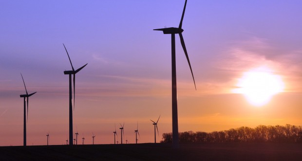 Turbines spin during sunrise at a wind farm