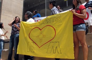 A group holds a sign saying
