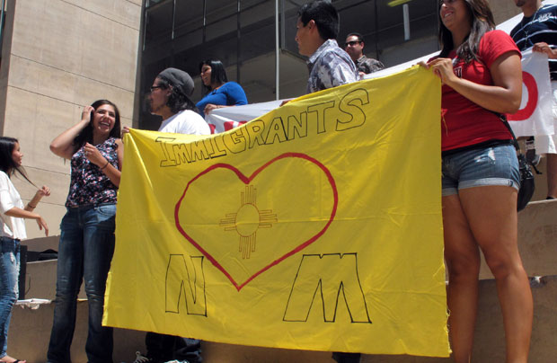 A group holds a sign saying