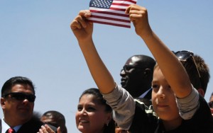 A little boy holds up an American flag