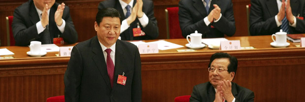 Politburo Standing Committee member Xi Jinping standing