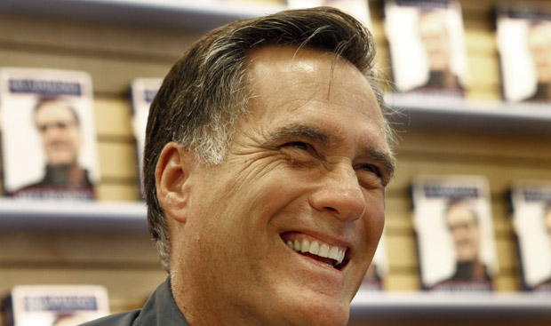 Gov. Romney at a book signing, smiling.