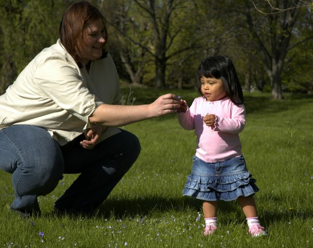Mom plays with daughter in the park