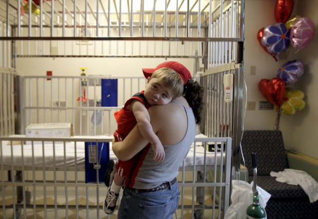 Mother holds her child in a hospital room