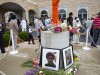 People walk around a flag pole outside the Sikh Temple of Wisconsin in Oak Creek, Wisconsin, the site of a hate-fueled, violent attack that left six members of the Sikh community dead.