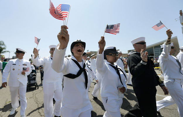 Soldiers in uniform march during a gay pride parade