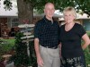 Retirees Rick Corley, left, and his wife Jean pose for a photo in front of their home in Moore, Okla.