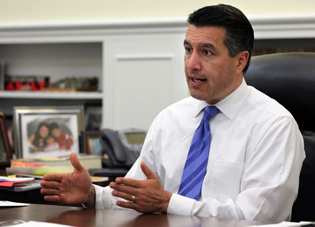 Nevada Gov. Brian Sandoval speaks in his office in Carson City, Nev.