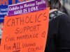 Catholic support of gay marriage holds sign saying so