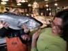 Fish vendor and customer with a 20 pound king alaskan salmon