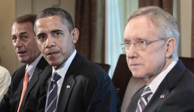 President Barack Obama, flanked by House Speaker John Boehner of Ohio, left, and Senate Majority Leader Harry Reid of Nev., meets with Congressional leadership in the Cabinet Room of the White House in Washington, Thursday, July 7, 2011