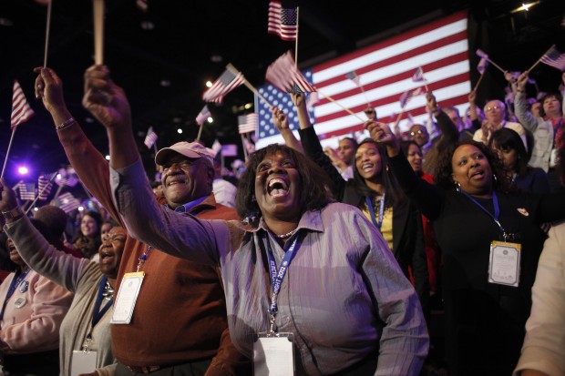 Supporters of President Barack Obama react to favorable media projections at the McCormick Place during an election night watch party in Chicago on election night.