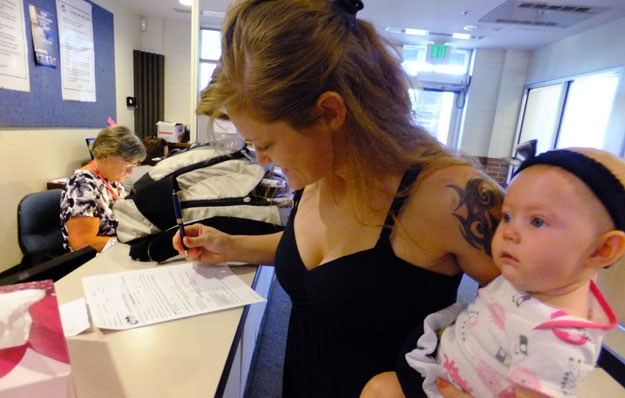 Woman fills out government assistance form