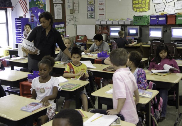 Teacher hanging out papers in class