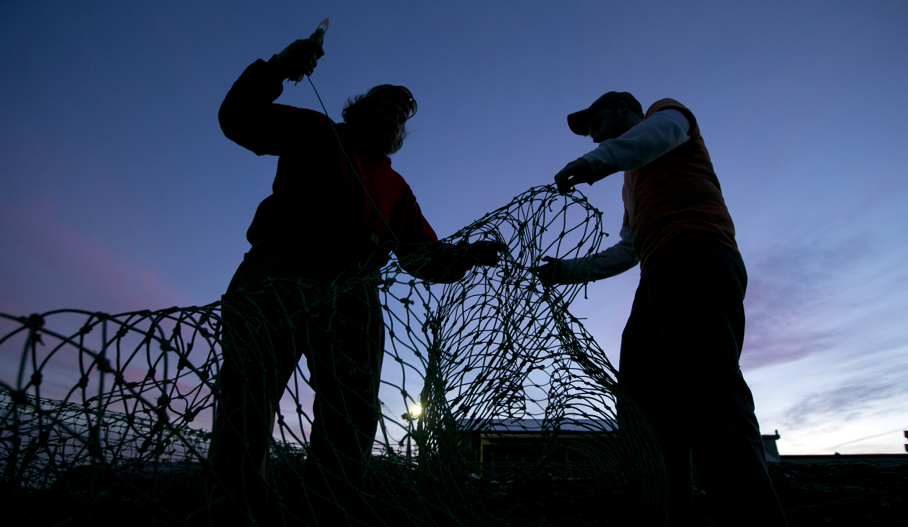 Fishermen mend nets