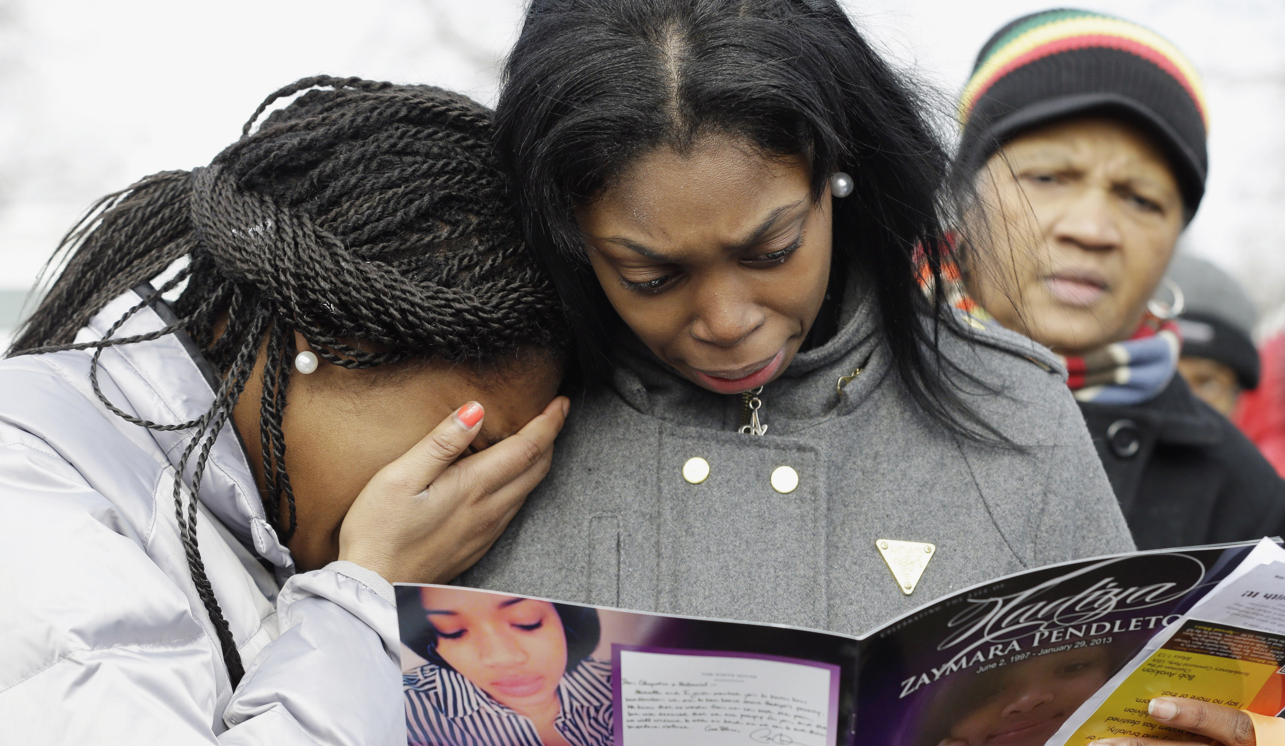Girls crying at funeral