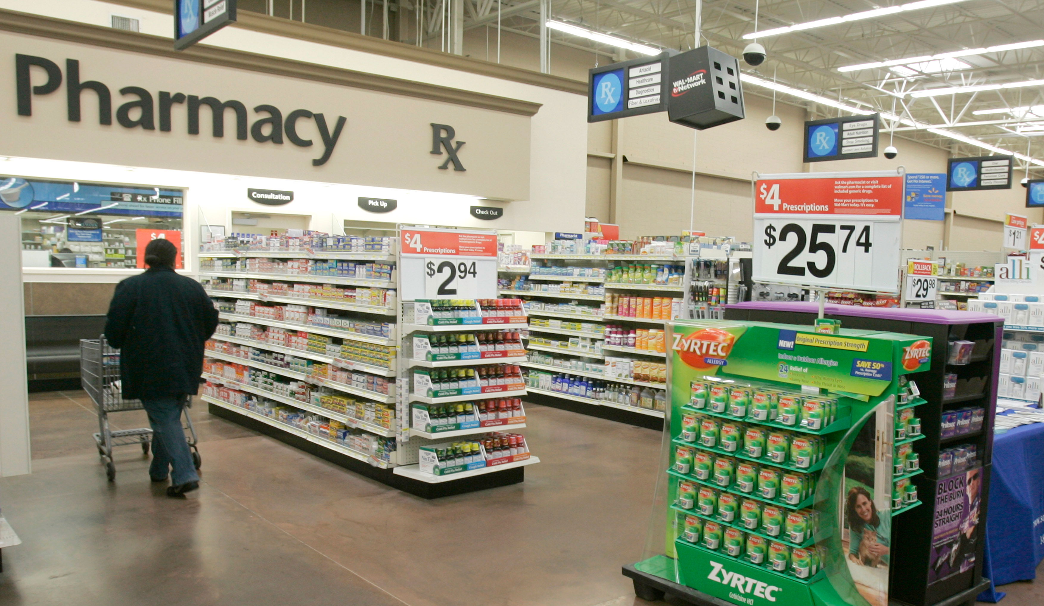 A shopper walks toward the pharmacy at a Little Rock, Arkansas, Wal-Mart store.