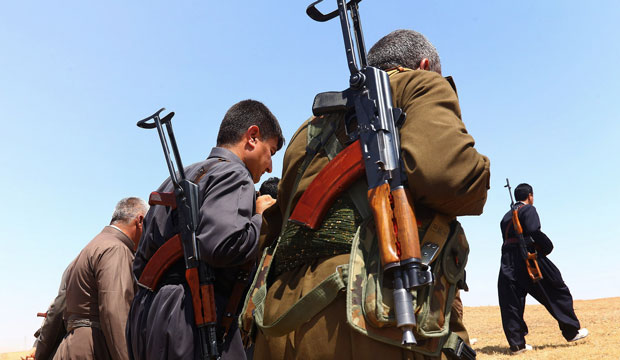Kurdish Peshmerga security forces stand guard in the outskirts of the northern city of Mosul, Iraq