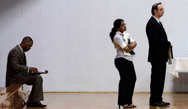 Job seekers wait in a line at a job fair in Southfield, Michigan.
