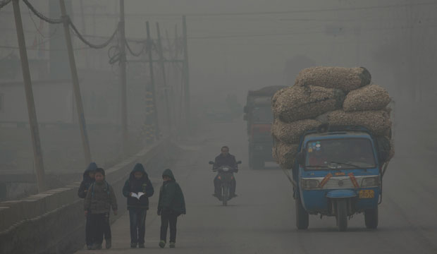 Children walk through pollution in Shijiazhuang, China.