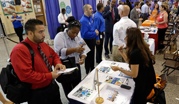 Job seekers attend a job fair.
