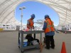 Construction workers prep wire for installing.