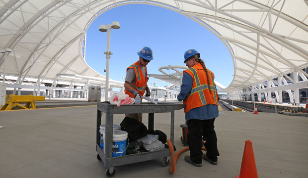 Construction workers prep wire for installing.
