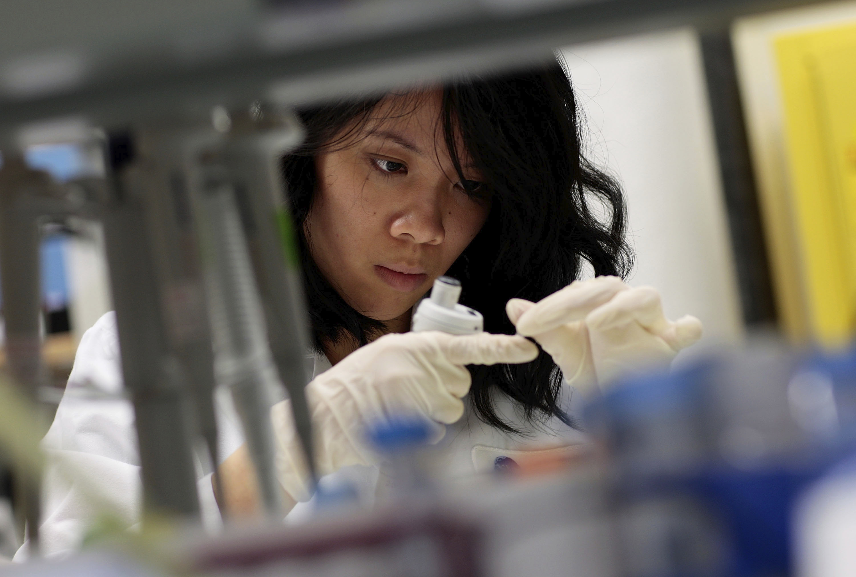 An intern works with a vaccine
