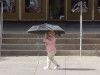 young girl holds umbrella