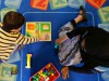 child and preschool teacher play