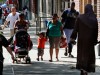 Pedestrians walk along 144th Street between 7th Avenue and Frederick Douglass Boulevard