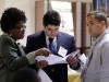 An instructor helps job candidates with their resumes.