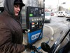 A motorist fills up his car's gas tank.