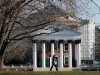 A student walks across the lawn