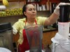 A woman makes juice