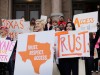 College students and abortion rights activists hold signs