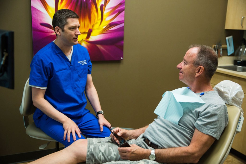 Dr. Adam Mileski talks with Army veteran Rory Killilea on June 24, 2017, in Spokane Valley, Washington.