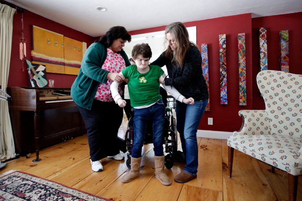 An in-home nurse helps steady her patient in Brentwood, New Hampshire, on March 17, 2017.