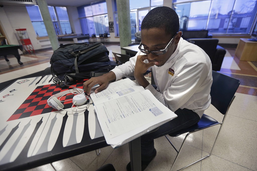 A student studies in a common area on his college campus, February 2013.