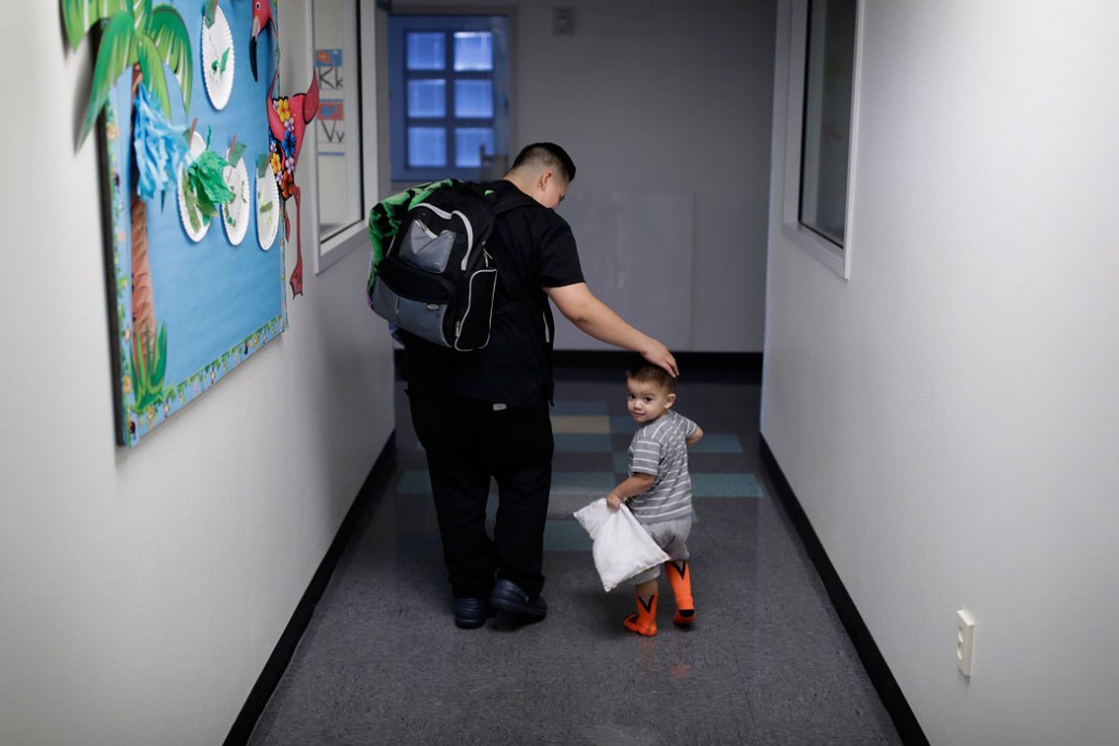 A mother picks up her 2-year-old son at a child development center in Las Vegas.