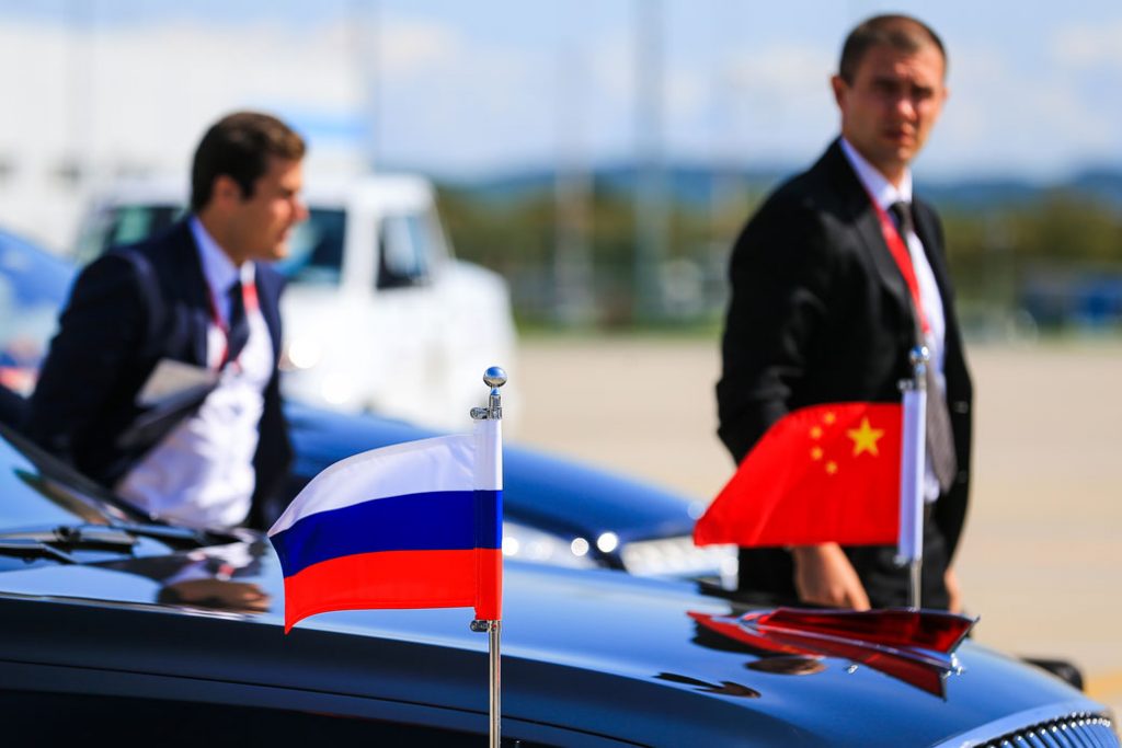 A motorcade car adorned with Chinese and Russian flags sits idle at Vladivostok International Airport, Russia, on September 11, 2018.