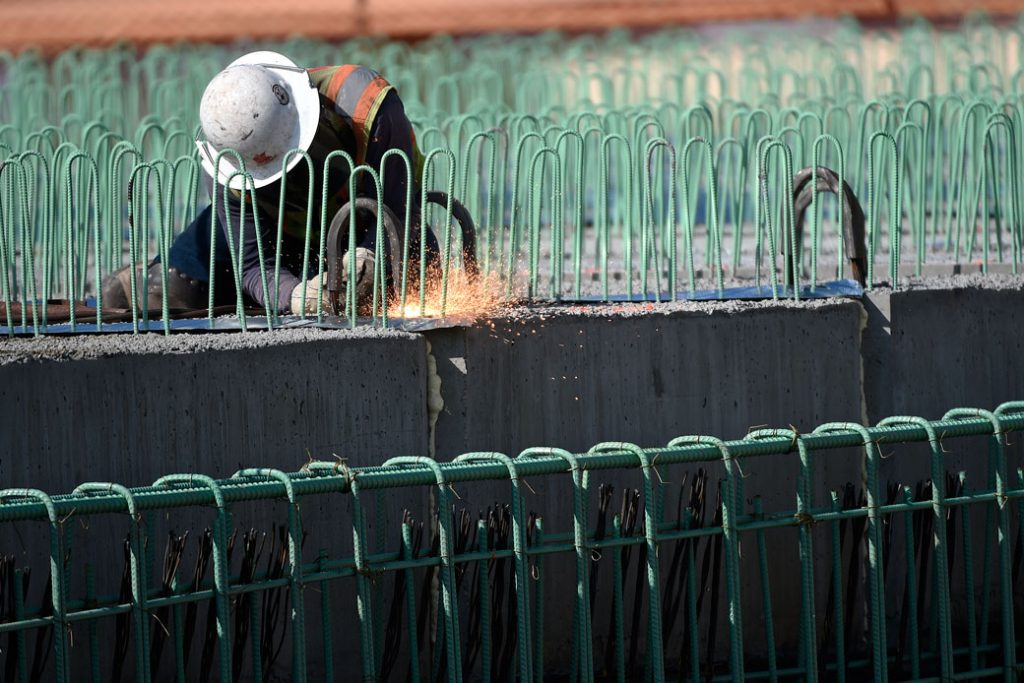 A construction worker uses a blowtorch on an interchange bridge in Englewood, Colorado, August 2016.
