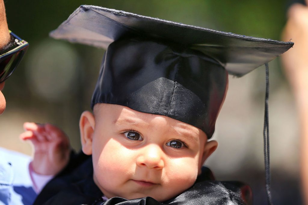 A baby attends his mother's graduation ceremony at the Massachusetts Institute of Technology in Cambridge, Massachusetts, June 2017.