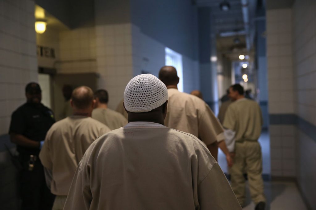 Incarcerated military veterans walk to the dining hall at an Enfield, Connecticut, rehabilitation center that helps to prepare inmates for successful reentry into society, May 2016.