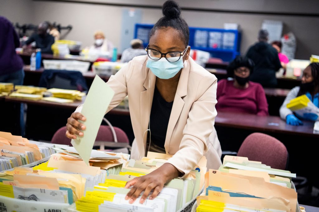 Election workers sort ballots at the Dekalb County Voter Registration and Elections Office in Decatur, Georgia, on November 2, 2020. 