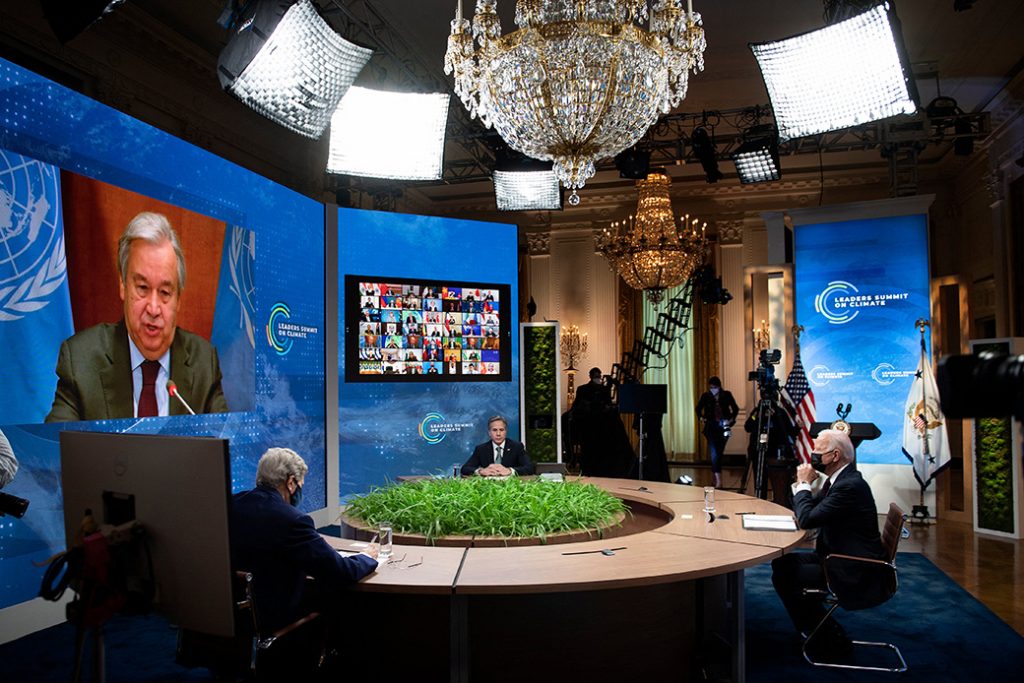 From left to right: Special Presidential Envoy for Climate John Kerry, Secretary of State Antony Blinken, and President Joe Biden listen as U.N. Secretary-General António Guterres speaks onscreen during a climate change virtual summit from the East Room of the White House campus, April 22, 2021, in Washington.