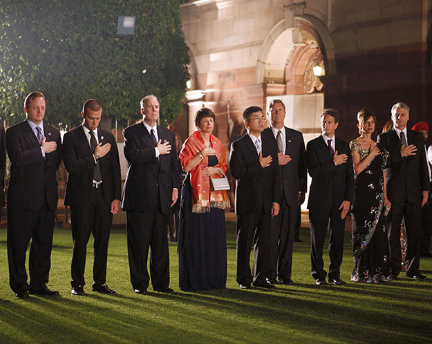 Members of the U.S. delegation stand during the playing of the U.S. national anthem during the state dinner for President Barack Obama and first lady Michelle Obama hosted by India's President Prathiba Patil and her husband Devisingh Ramsingh Shekhawat at Rashtrapati Bhavan in New Delhi, India, Monday, Nov. 8, 2010. From left are: Press Secretary Robert Gibbs, speech writer Jon Favreau, National Security Adviser Tom Donilon, senior adviser Valerie Jarrett, Commerce Secretary Gary Locke, Agriculture Secretary Tom Vilsack, Treasury Secretary Timothy Geithner, U.S. Ambassador to India Tim Roemer and wife Sally.