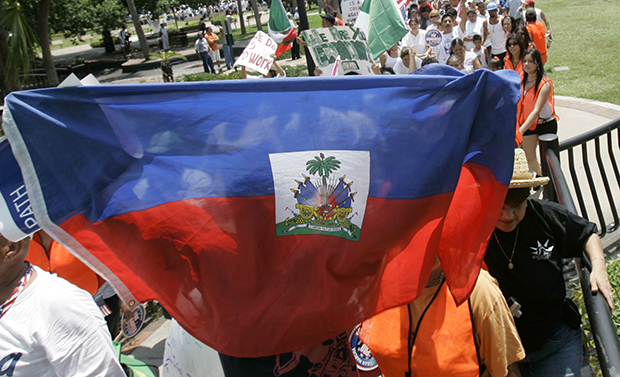 A protester holds up a Haitian flag during a march for immigration reform in Orlando, Florida.