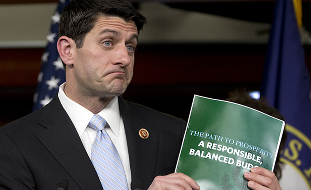 House Budget Committee Chairman Paul Ryan (R-WI) holds up a copy of the FY 2014 budget resolution as he speaks during a news conference on Capitol Hill in Washington, Tuesday, March 12, 2013.
