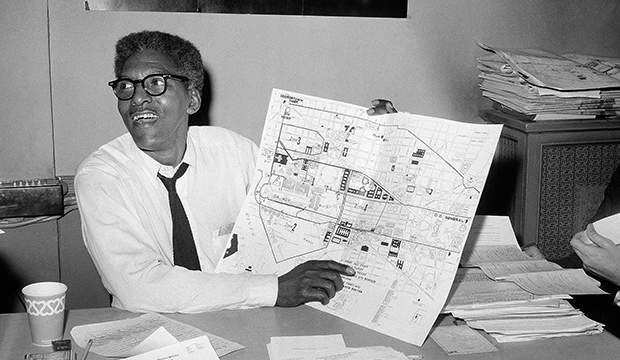 In this August 24, 1963, file photo, Bayard Rustin points to a map showing the path of the March on Washington during a news conference at the New York City headquarters.